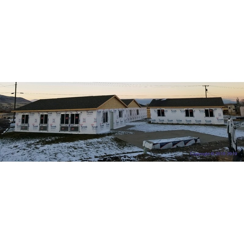 Building site - lawn, slab, sidewalks, windows, and doors are installed